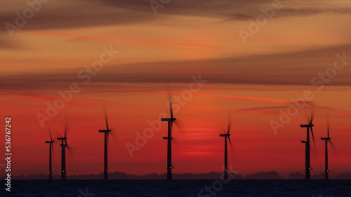 Off shore wind turbines at sunrise. © daviddales