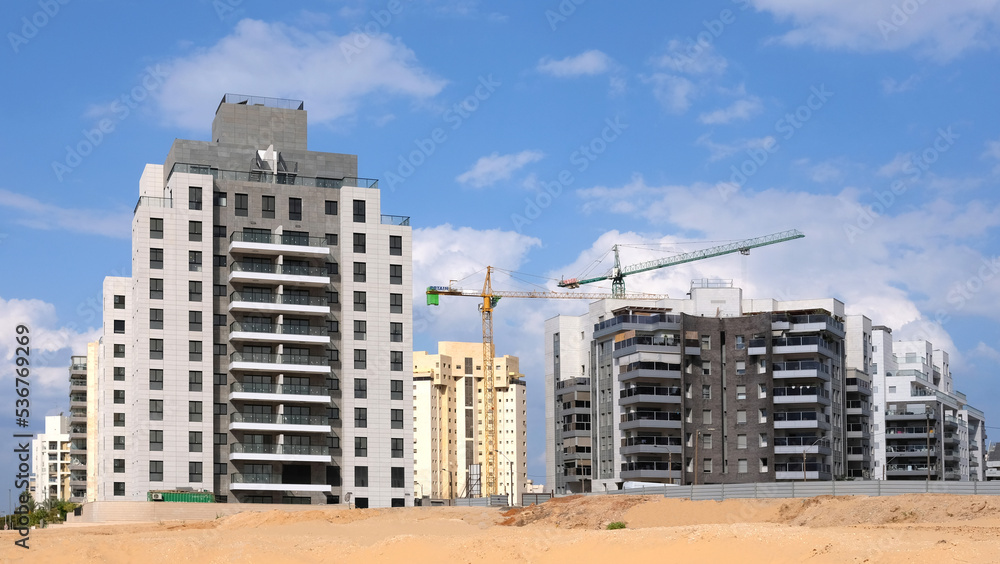 City construction among desert dunes. Building yard of Housing construction of houses in new area of the city Holon in Israel