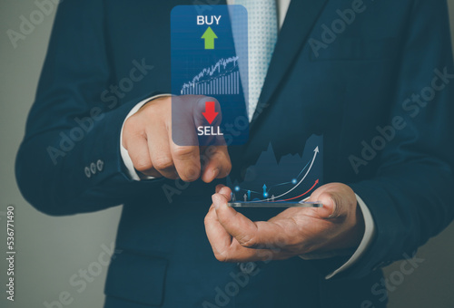 Businessman analysing trading graph financial data. Business finance background.Business finance technology and investment concept.2023 business finance technology and investment concept.