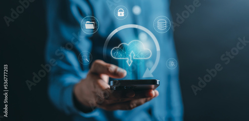 Businessman using smart phone cloud computing to download and loading data information and upload on system network application. Technology transformation concept photo