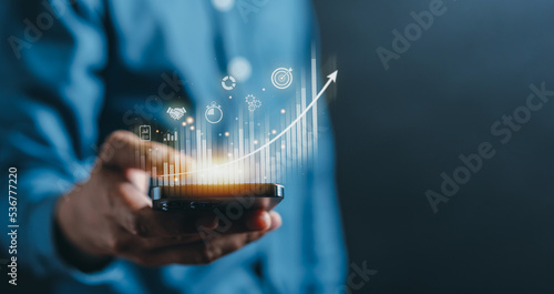 Business finance technology and investment concept. Stock Market Investments Funds and Digital Assets. businessman using mobile phone for analyzing forex trading graph financial data. Business finance