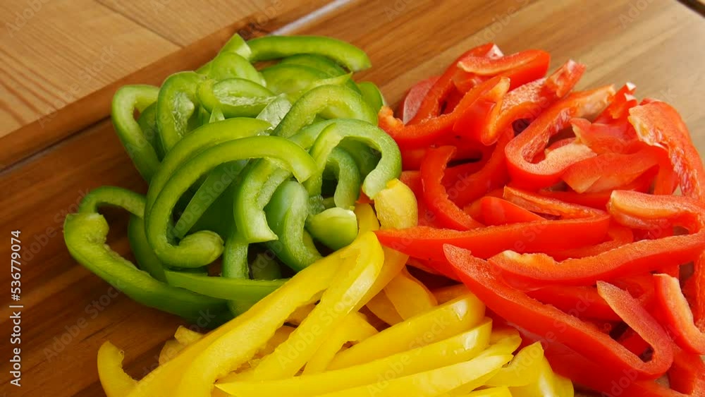 Sliced multi-colored peppers on the board. Sliced multi-colored peppers on the board.