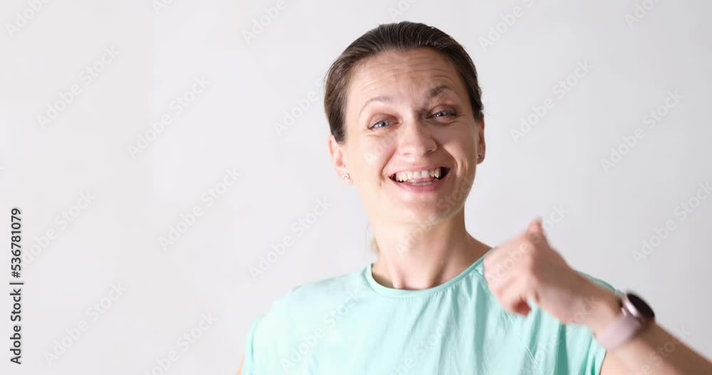 Portrait of smiling woman showing thumbs up. Portrait of smiling woman showing thumbs up.