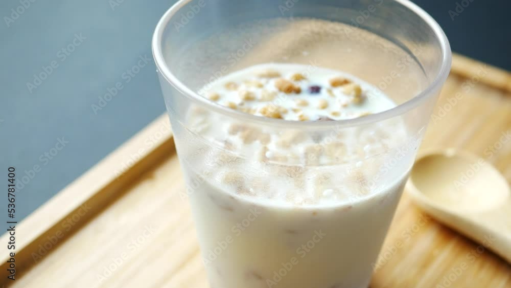 breakfast cereal and milk in a glass on table breakfast cereal and milk in a glass on table