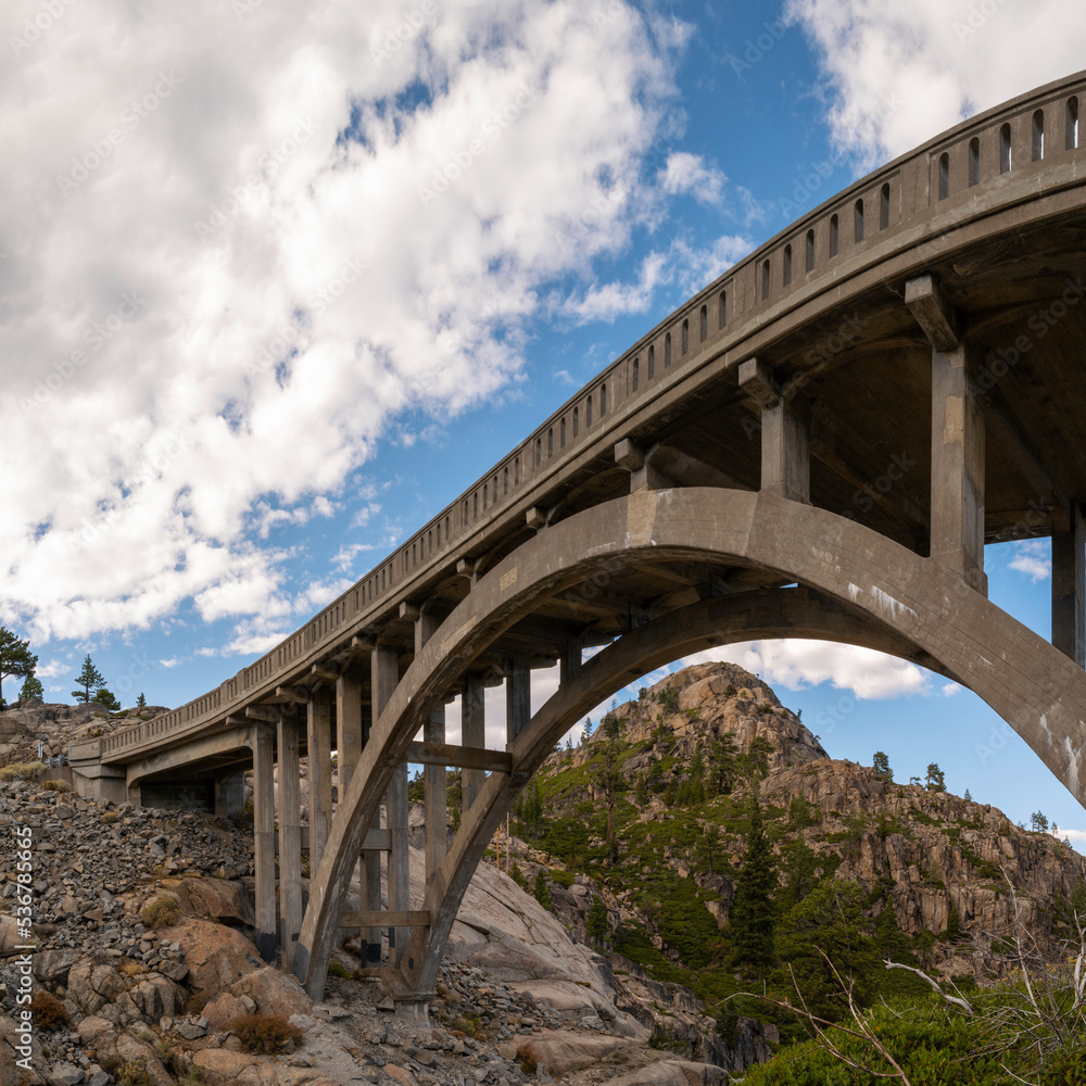 Donner Summit Bridge, aka Rainbow Bridge over Donner Pass near Lake Tahoe, with dramatic clouds, in Truckee, Nevada County, Northern California Donner Summit Bridge, aka Rainbow Bridge over Donner Pass near Lake Tahoe, with dramatic clouds, in Truckee, Nevada County, Northern California
