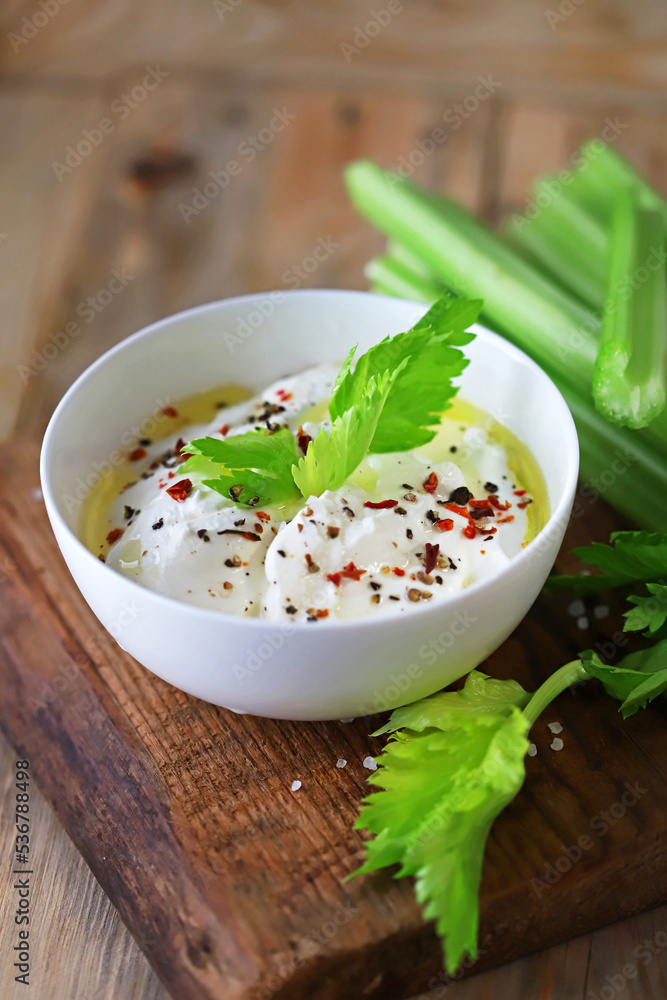 Celery sticks with white sauce in a bowl. Healthy food. Celery sticks with white sauce in a bowl. Healthy food.
