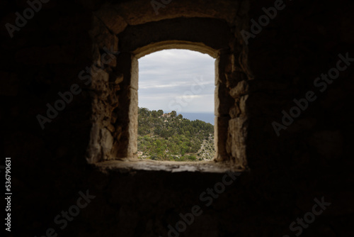 Details with the view from a window inside a mediaeval fortress on the French riviera during a cloudy spring day.