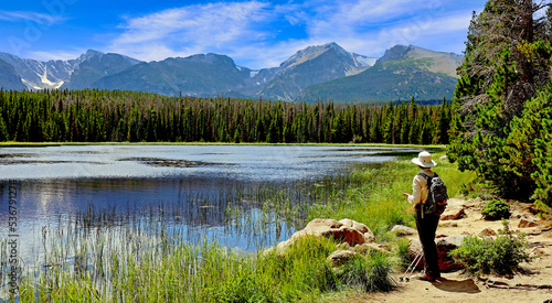 A hiker pauses at Lake Bierstadt, a popular hiking destination in Colorado's Rocky Mountain National Park