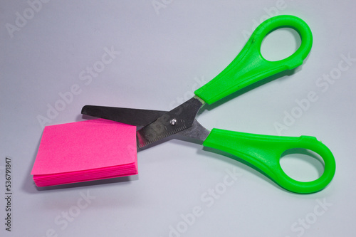 Metal scissors with green plastic parts
