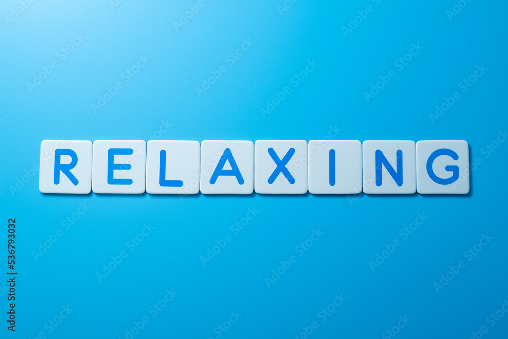 Word RELAXING on blue background,RELAXING Concept Word RELAXING on blue background,RELAXING Concept
