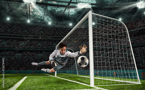 Obraz na plátne Soccer goalkeeper that makes a great save and avoids a goal during a match at th