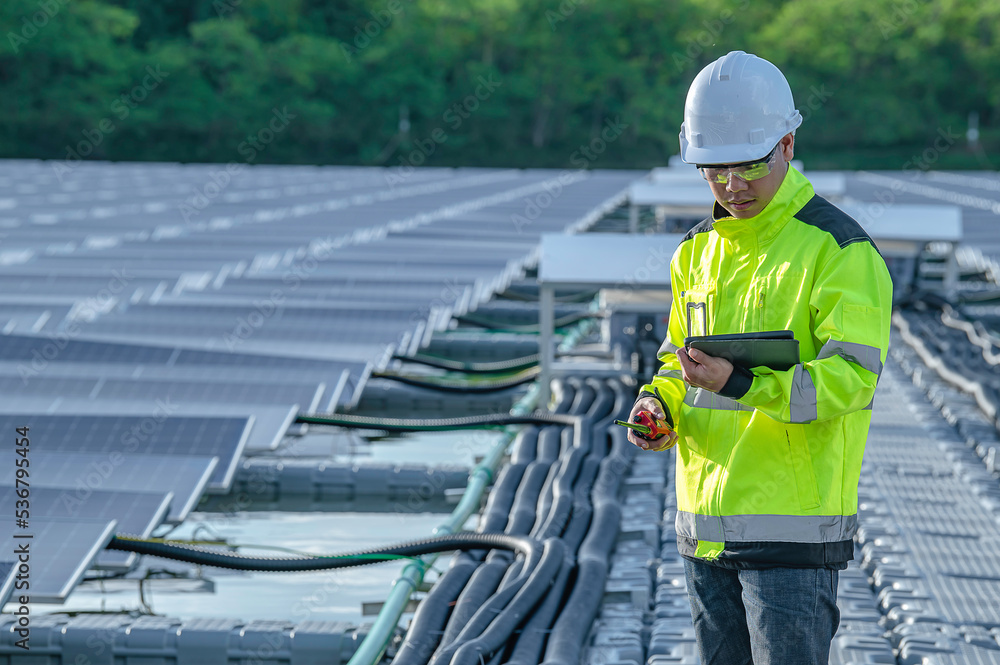 Asian engineer working at Floating solar power plant,Renewable energy,Technician and investor solar panels checking the panels at solar energy installation Asian engineer working at Floating solar power plant,Renewable energy,Technician and investor solar panels checking the panels at solar energy installation