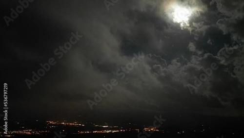 Cloudy night Timelapse with full moon over Tuscany Mugello valley photo