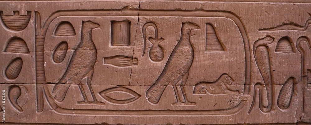 Ancient egyptian hieroglyphs carved on walls of Kom Ombo temple in Aswan, Egypt 