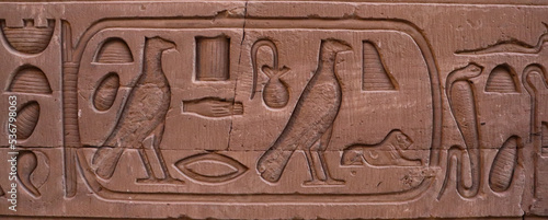 Ancient egyptian hieroglyphs carved on walls of Kom Ombo temple in Aswan, Egypt 