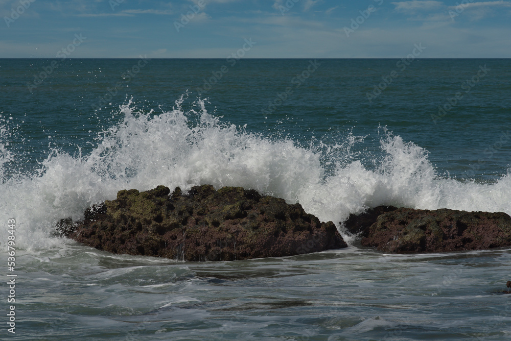 Fototapeta premium West Africa. Senegal. The waves of the Atlantic Ocean beat against the rocks of volcanic origin on the beach of the resort town of Ngaparou.