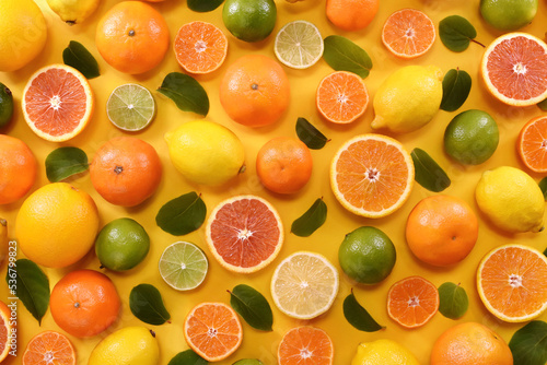 Colorful bright background of fresh ripe sweet citrus fruits in basket: orange and tangerine, green lime and yellow lemon