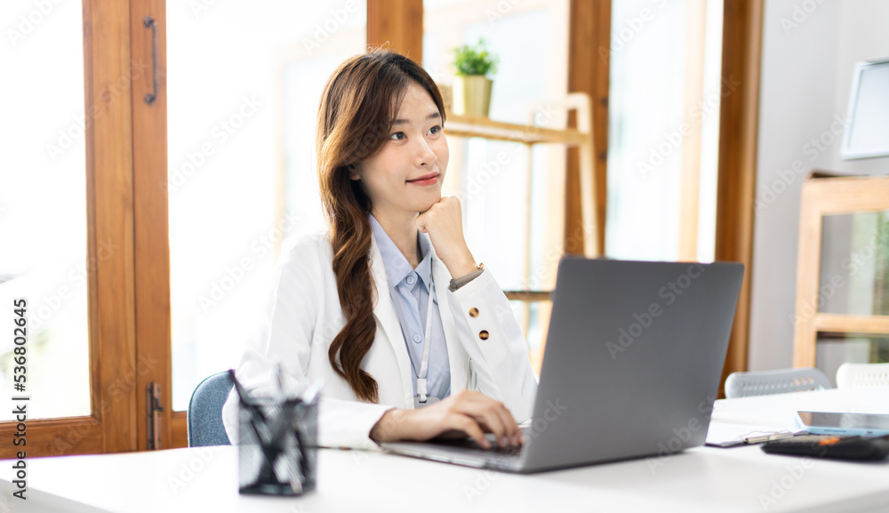 Businesswoman using laptop to work, Asian woman working in the office, Financial clerk or accountant with documents and equipment working on the desk, Using computers for financial transactions. Businesswoman using laptop to work, Asian woman working in the office, Financial clerk or accountant with documents and equipment working on the desk, Using computers for financial transactions.