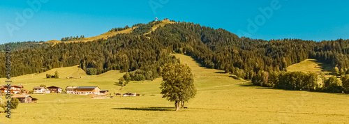 Beautiful alpine summer view with the famous Jacob cross in the background near Saint Jacob in Haus, Tyrol, Austria