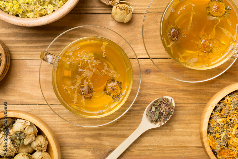 Herbal tea with ingredients on wooden background, top view Herbal tea with ingredients on wooden background, top view