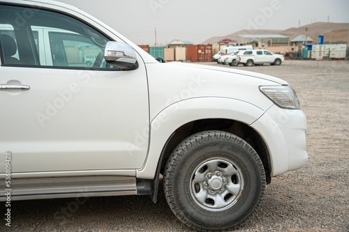 Detail of a white pickup truck on the construction site photo