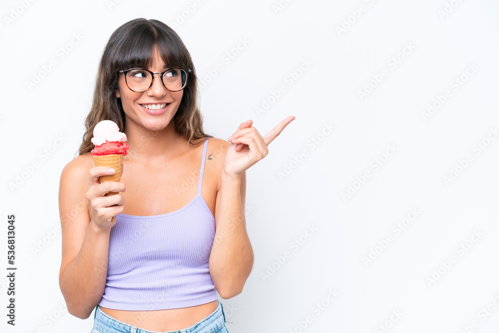 Young caucasian woman with a cornet ice cream over isolated white background intending to realizes the solution while lifting a finger up Young caucasian woman with a cornet ice cream over isolated white background intending to realizes the solution while lifting a finger up
