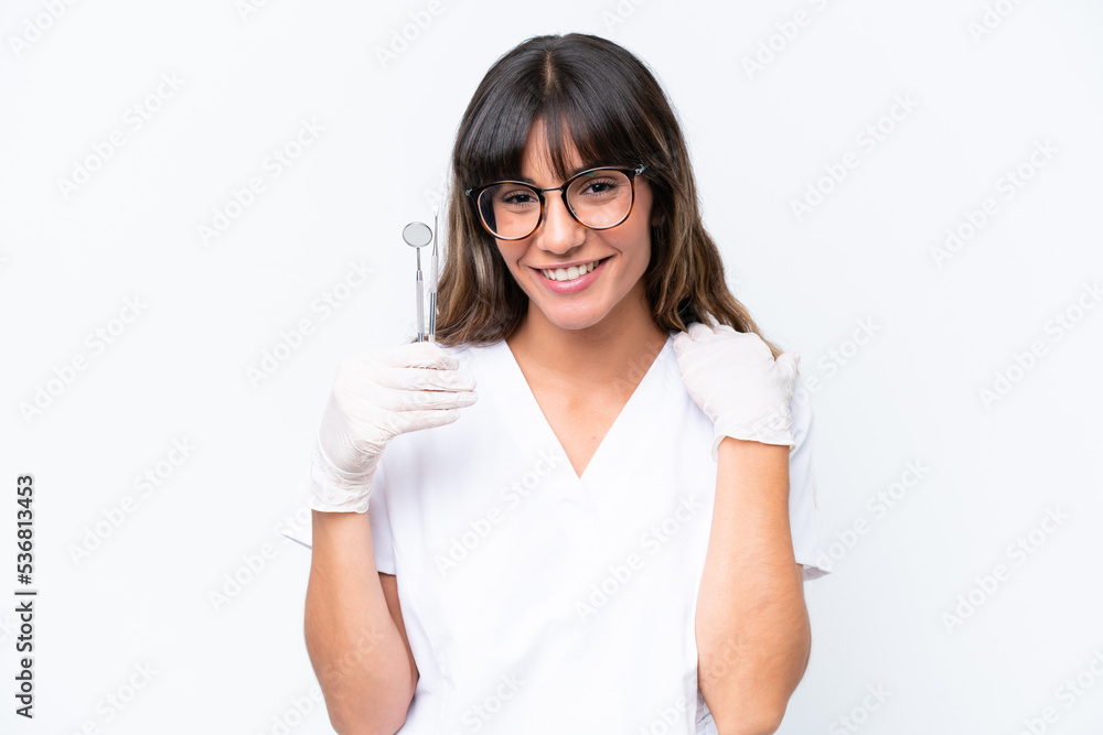 Dentist caucasian woman holding tools isolated on white background laughing Dentist caucasian woman holding tools isolated on white background laughing