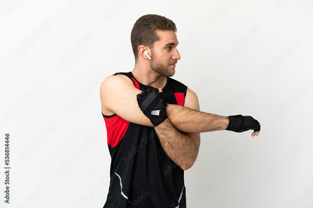 Handsome blonde man over isolated white background stretching arm