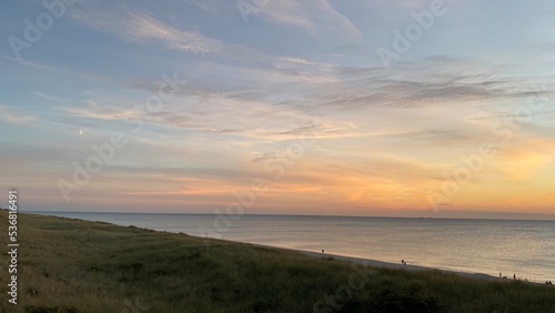 Sunset over the North Sea with dune grass in front on the island of Sylt in Germany 