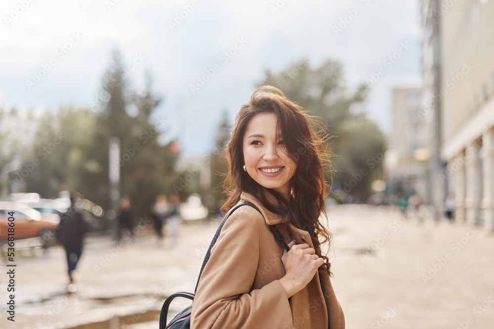 Fototapeta premium Lifestyle portrait pretty Asian kazakh woman with brilliant smile on street