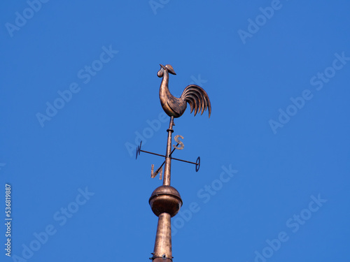 A weather vane on a church tower, here a catholic church.