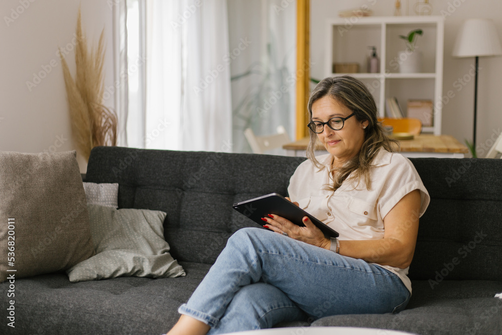 Adult woman having video call at home using tablet Adult woman having video call at home using tablet