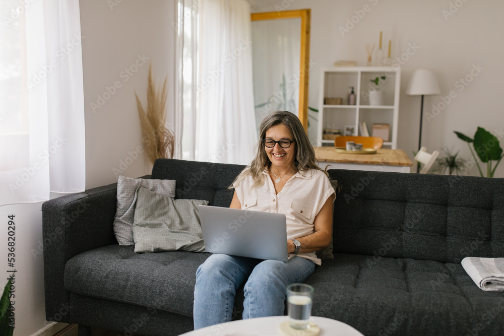 Adult woman using laptop at home for online meeting Adult woman using laptop at home for online meeting