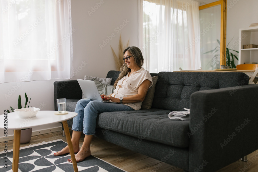 Adult woman using laptop at home for online meeting Adult woman using laptop at home for online meeting