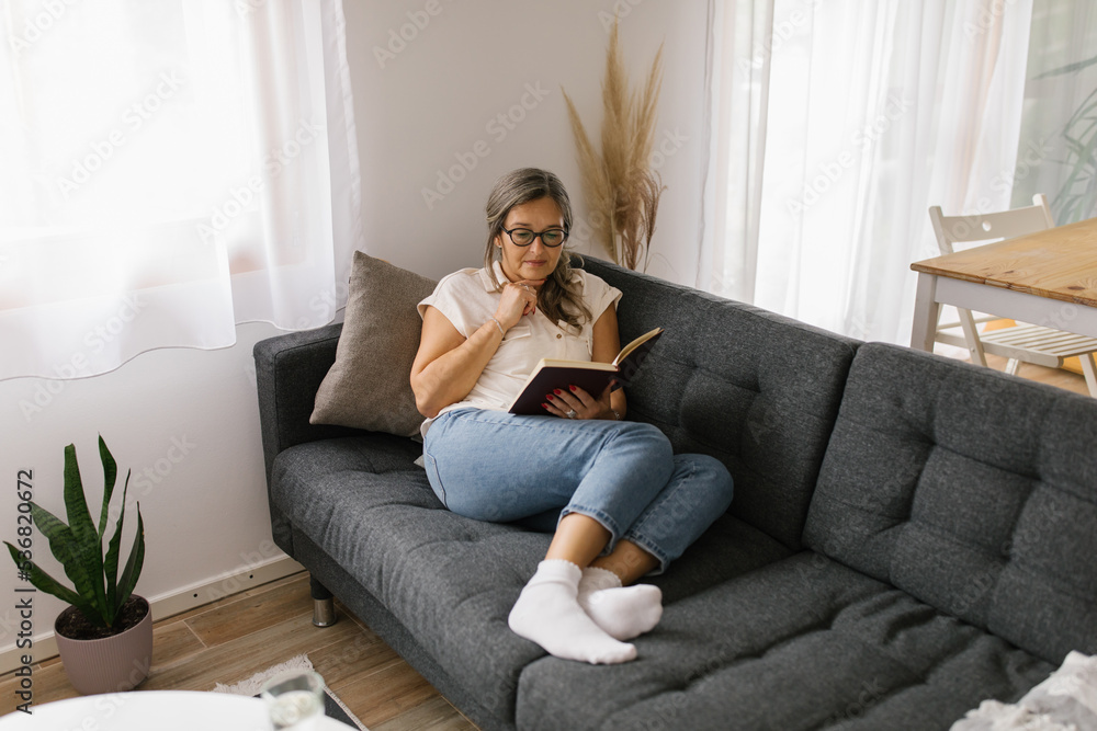 Woman reading a book at home Woman reading a book at home