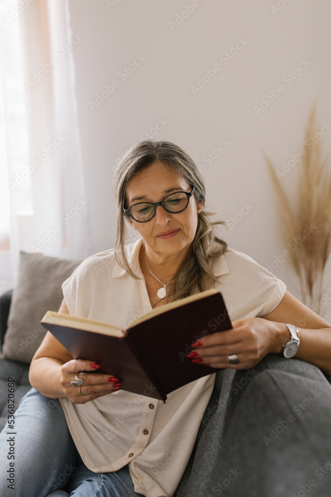 Woman reading a book at home Woman reading a book at home