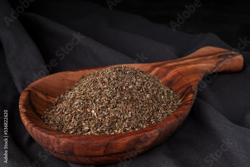 Dried chopped provence herbs in a wooden  bowl photo