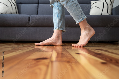 cropped shot of woman walking barefoot in room photo