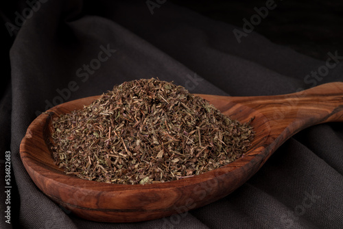 Dried chopped provence herbs in a wooden  bowl photo