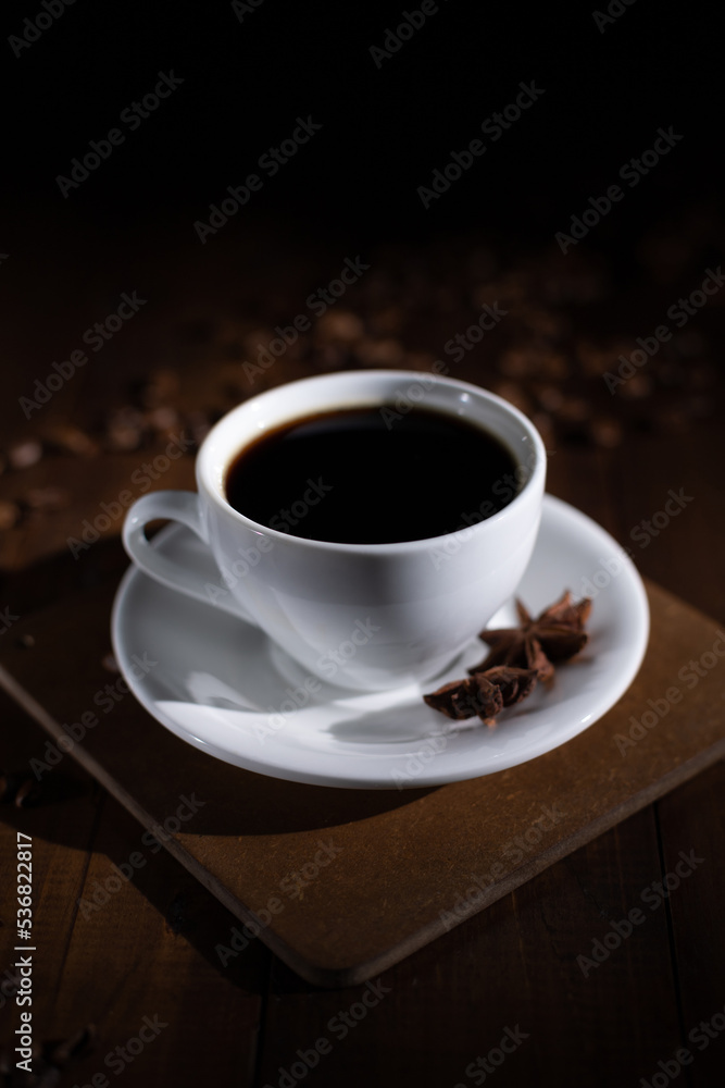 Cup of coffee with beans at wooden table Cup of coffee with beans at wooden table