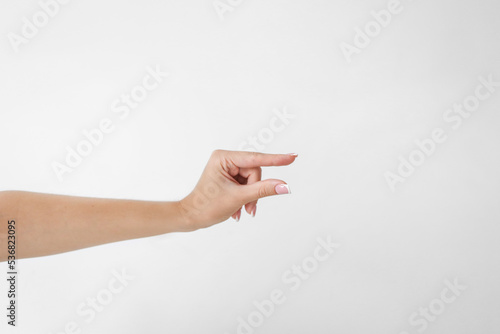 Woman hand holding two fingers showing size on a white background