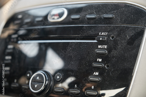Dusty, uncleaned car radio closeup