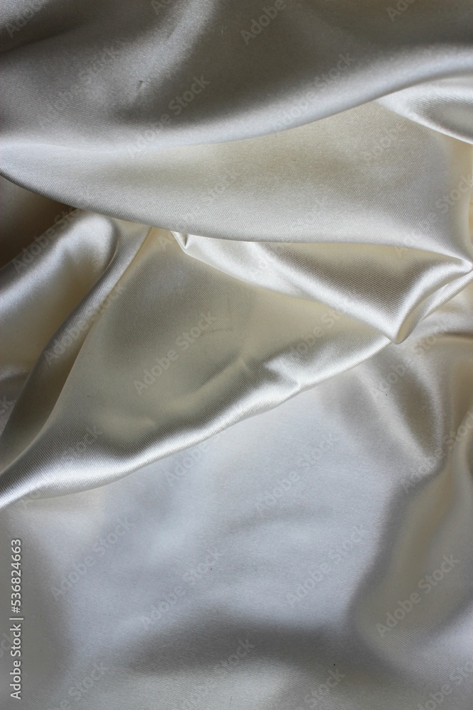 Beautiful white mother-of-pearl fabric, folded in folds. Silk, satin or satin ribbon. Beautiful white mother-of-pearl fabric, folded in folds. Silk, satin or satin ribbon.