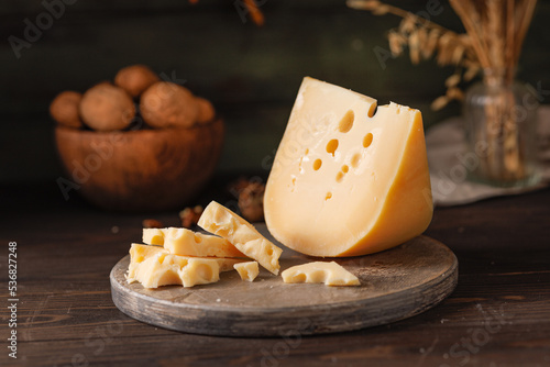 cheese with eyes on a wooden board on the table.
