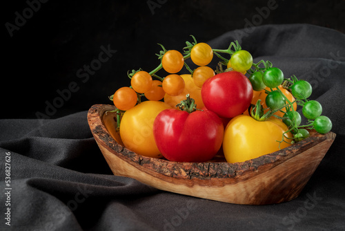 Fototapeta Naklejka Na Ścianę i Meble -  Yellow tomatoes branch on table  background, healthy food