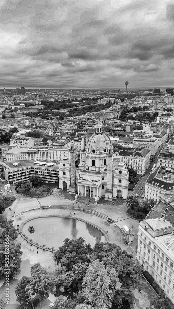 Vertical aerial view of Vienna, Austria. Central streets and buildings from drone on a cloudy day