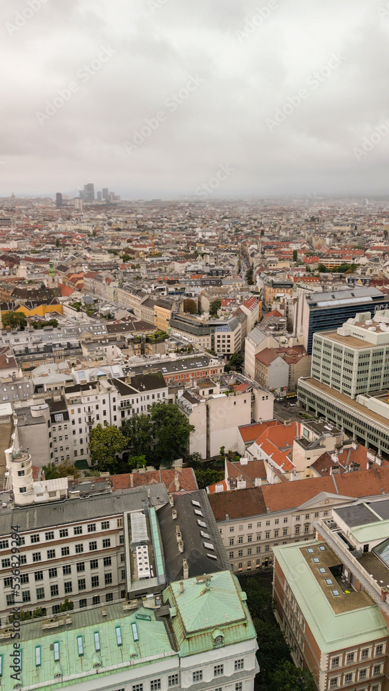 Vertical aerial view of Vienna, Austria. Central streets and buildings from drone on a cloudy day