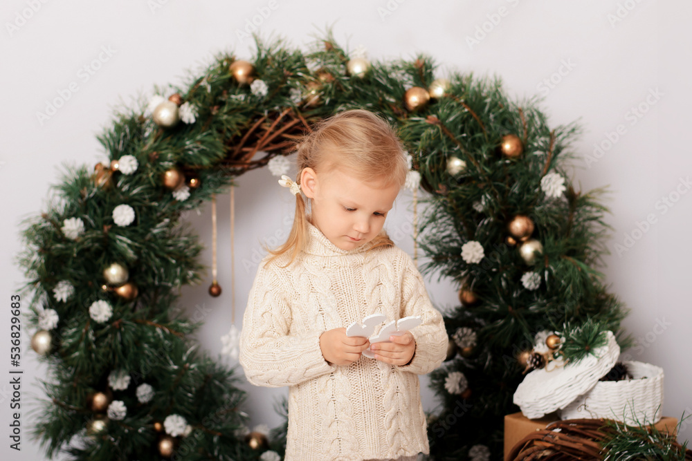 Merry Christmas and Happy New Year. Cute girl with christmas presents. Little girl in a Christmas decorated studio in pastel colors. Merry Christmas and Happy New Year. Cute girl with christmas presents. Little girl in a Christmas decorated studio in pastel colors.