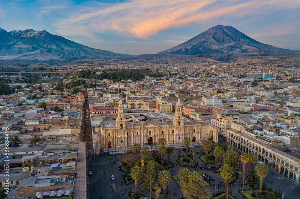 Drone shot of the Plaza de Armas with the Arequipa Cathedral and the Misti Volcano in the background in Peru at the blue hour/sunset