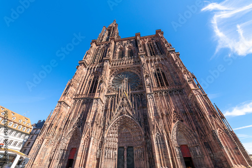 The west end facade with doorway, rose window and spire of the Our Lady of Strasbourg or Cathédrale Notre Dame de Strasbourg cathedral, in Strasbourg, France.